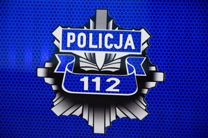 Policyjna gwiazda z napisem Policja i nr 112